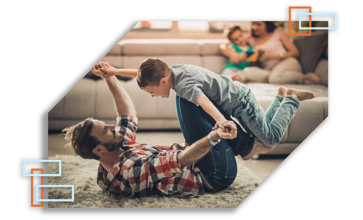 Family playing on couch in room.