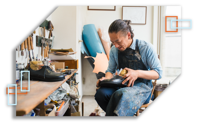 Male business owner fixing shoes.