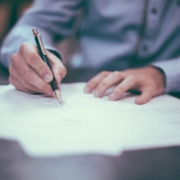 Man at a desk writing on papers.