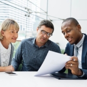 Business review meeting between three people.