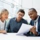 Business review meeting between three people.